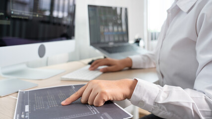 Asian Woman programmer typing source codes Programming On Computer in office, freelance web developer concept.