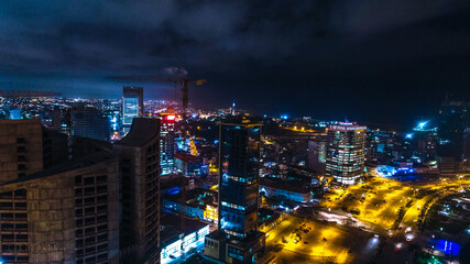 Road, lights and sea at night.
Luanda city captured from the top