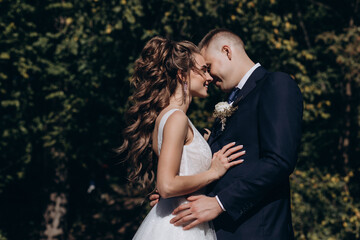 Wall Mural - Photo session of the newlyweds against the backdrop of a picturesque area. Forest and rocks.