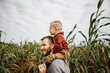 Father and son exploring corn maze in the fall
