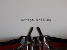 The Words "script Writing" Typed On A Typewriter, Close Up