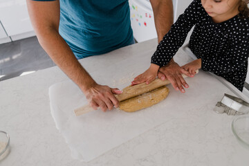 Wall Mural - father and daughter rolling out cookie dough together