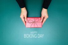Happy Boxing Day, Young Woman Hand With A Gift Box Offer To Rece