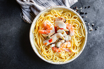 spaghetti seafood pasta shrimp, mussels, squid and more second course top view copy space for text food background rustic