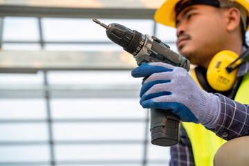 Aufkleber - Construction worker using an electric pneumatic drill bricks and build interior walls,Professional on the construction site,The concept of electrician and handyman.