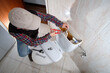 Plumber repairing the toilet in a bathroom