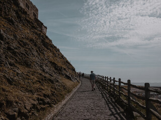 winding pathway up to coastal castle in England 