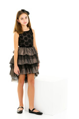 Wall Mural - Little girl in an elegant dress.The concept of a happy childhood