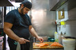 © Natalia - Young chef is preparing a typical dish  whith salmon in restaurant. She brings to the table good and tasty cuisine