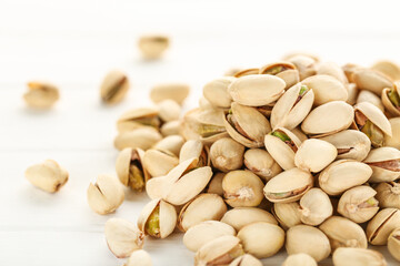 Poster - Pistachios on white wooden table