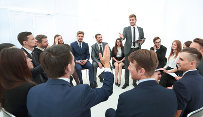 Sticker - skilled coach asks questions to the participants of the training.