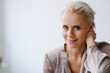 © KNSY/Westend61 - Close-up of confident businesswoman against white wall in office