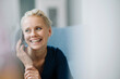 © KNSY/Westend61 - Close-up of cheerful businesswoman talking over smart phone while sitting in office