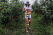 © Oxana Guryanova/Westend61 - Apples falling from basket held by woman in orchard