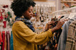 © AD Photography/Stocksy - Portrait Of A Afro Woman During A Shopping Day