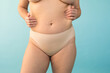 © Sergey Filimonov/Stocksy - Unrecognizable plus size model kneading body