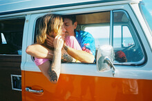 Hip Couple On Beach With Daisies And Vw Van In California