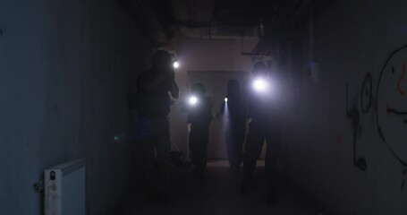 Wall Mural - Soldiers with flashlights inspecting dark corridor