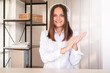 © golubovy - Online communication. Webinar training. Teamwork stream. Digital technology. happy woman in white headphones and shirt looking at camera light home office interior background.