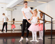 © JackF - Two little girls practicing choreographic elements in ballet hall