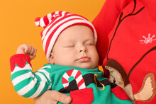 Mother With Cute Little Baby In Elf's Costume On Color Background