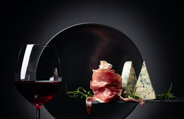 Wall Mural - Glass of red wine with traditional mediterranean snacks.