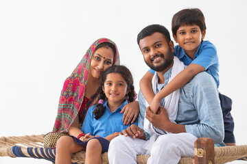 PORTRAIT OF A COMPLETE RURAL FAMILY HAPPILY LOOKING AT CAMERA
