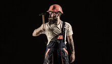 Builder In Helmet, Hammer, Handyman, Builders In Hardhat. Hammer Hammering. Bearded Builder Isolated On Black Background. Bearded Man Worker With Beard, Building Helmet, Hard Hat