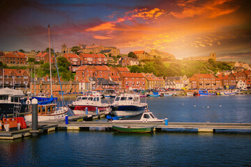 Whitby abbey is a seaside town and port at sunset in North Yorkshire, UK