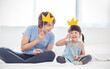 © paulaphoto - Portrait of asian mother and child daughter playing having fun together. Beautiful funny girl and mommy have crowns on sticks. Fun love family lifestyle single mom love mother’s day holiday concept