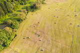 Fototapeta Do pokoju - a large meadow with hay bales from above