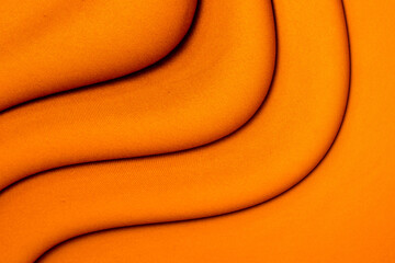 Wall Mural - Background of orange fabric. Creases on the fabric. Texture of cotton fabric.