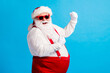 Photo of style stylish fat santa claus with big belly beard raise fists win x-mas christmas lottery wear suspenders overalls sunglass isolated over blue color background