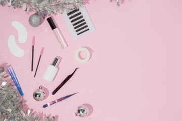 Wall Mural - New year and Christmas for the masters of eyelash extension. Things for the work of lashmakers, artificial eyelashes. Top view, pink background, free space for text.