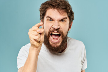 bearded man emotions facial expression gestures hands close-up blue background