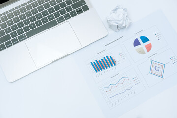 charts and graph on paper sheets and laptop on white background in business concept