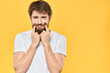 © SHOTPRIME STUDIO - Bearded man emotions gestures with hands facial expression white t-shirt yellow background