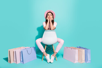 Canvas Print - Full body photo upset girl sit chair with shopping bags look empty space difficult choice concept isolated on turquoise color background