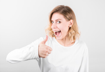 Sticker - Young happy cheerful woman showing thumb up