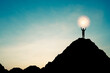 Silhouette of businessman holding world and connection line on the top of mountain with over blue sky and sunlight. It is symbol of leadership successful achievement with goal and objective target.