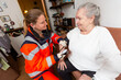 © Katja - a paramedic measures an old woman's blood pressure