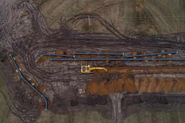 aerial photograph of the laying pipe of large diameter in clay soil. Autumn