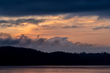 Wall Mural - sunrise mt rainier through the clouds