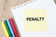© Volha - Penalty inscription on a yellow card lying on a notebook, office desk.