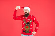 © be free - surprised bearded guy in warm knitted sweater and santa claus hat celebrate winter holiday of chistmas and feel merry about xmas gifts, knitwear fashion
