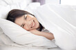 © charnsitr - Asian Woman Lying on Her Bed and Smiling to the Camera