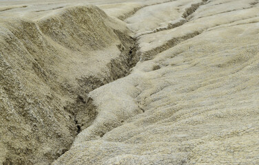 Landscape with cracked soil from Mud Volcanoes, at Paclele Mari, Romania. Volcanic rocks and lava of mud volcanoes. Lunar landscape in Europe