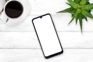 Wall Mural - top view of a new modern smartphone mockup with blank white screen on a wooden vintage table with co