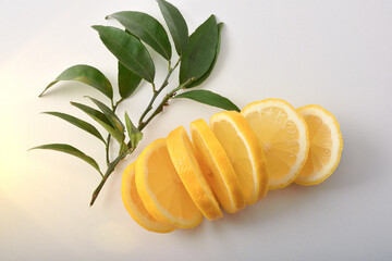 Wall Mural - Lemon cut into slices and leaveson white table top