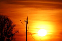 Wind Turbine And Red Sky At Sunset